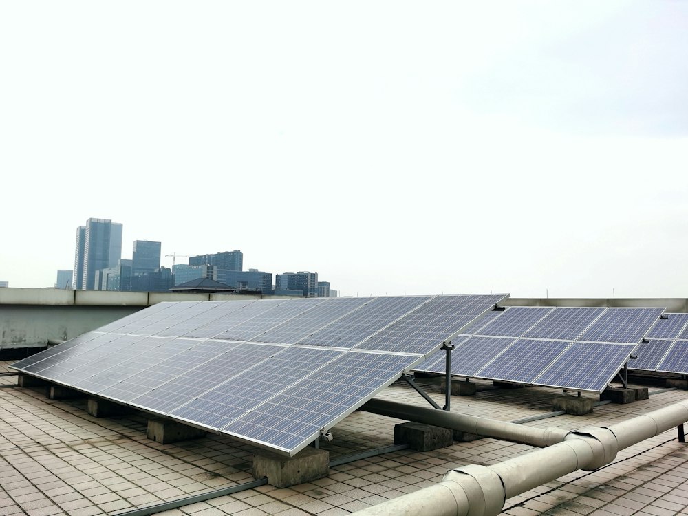 Solarmodule auf einem Flachdach mit Blick auf die Stadt